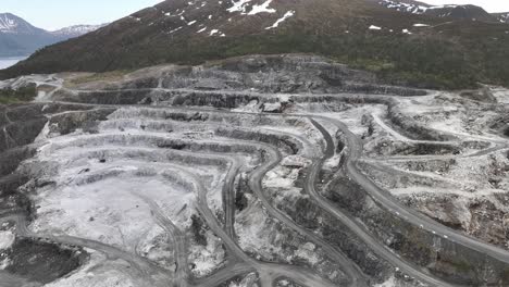 Limestone-Quarry-and-Limestone-mining-site-for-company-Visnes-Kalk-AS-between-Molde-and-Kristiansund-in-Norway---Aerial-showing-carved-out-and-damaged-mountain