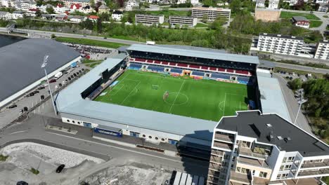 Color-Line-Stadium-soccer-arena-in-Alesund-Norway---High-angle-aerial-above-field-with-players-warming-up-before-match