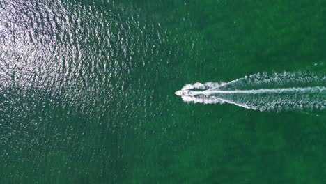 Stunning-aerial-4K-drone-footage-of-a-boat-gliding-across-the-enchanting-sea
