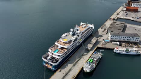 Cruise-ship-SH-Diana-from-Swan-Hellenic-company-is-moored-alongside-in-Alesund-Norway---High-angle-aerial-in-sunny-weather