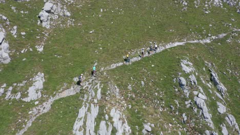 Aerial-overview-of-a-group-of-climbers-walking-uphill-on-a-high-mountain