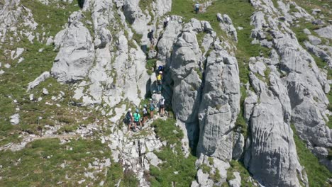 Jib-down-of-kids-climbing-up-a-steep-mountain-ledge