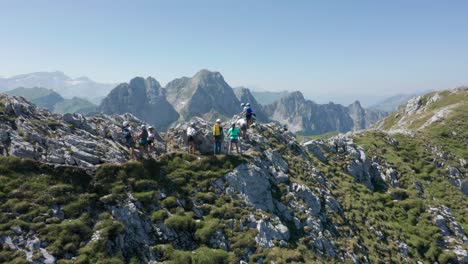 Aerial-of-group-of-climbers-moving-over-a-narrow-mountain-ledge