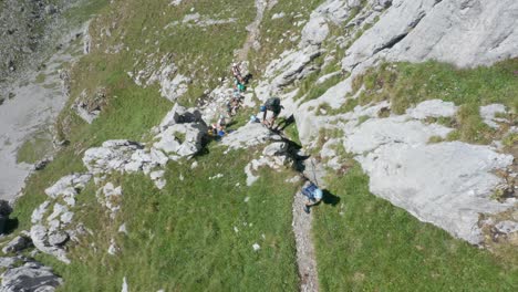 Top-down-view-of-group-of-climbers-going-up-a-steep-and-rocky-ledge