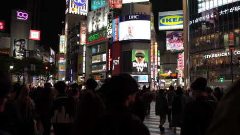 TOKYO,-JAPAN---APRIL-8,-2023:-People-walking-in-Shibuya-shopping-area-in-drizzle-evening