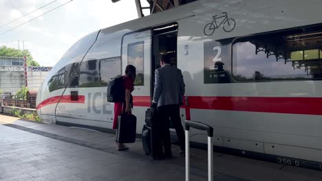 Passenger-with-baggage-entering-German-ICE-Express-Train-at-Hamburg-Train-Station-in-summer---Slow-motion-static