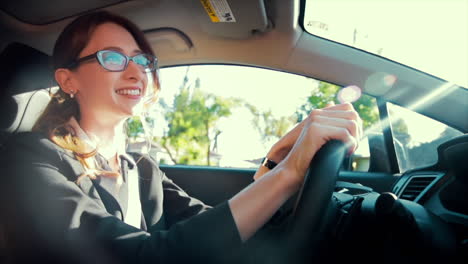 Attractive-caucasian-business-woman-driving-while-enjoying-listening-to-music