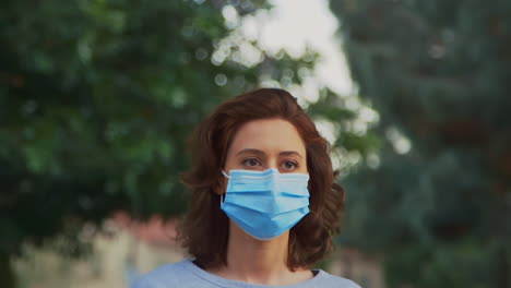 [Camera-Used:-Canon-C300]-Caucasian-woman-wearing-a-surgical-face-mask-walking-down-the-street