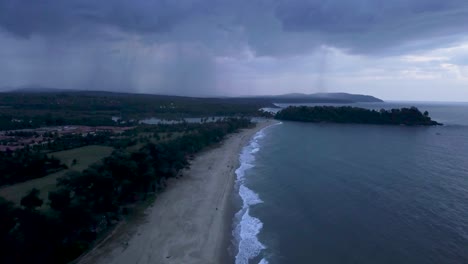 Sea-Waves-Roll-On-The-Sandy-Beach,-Rajbaga-Beach-In-Canacona,-South-Goa,-India-During-Sunset---aerial-drone-shot