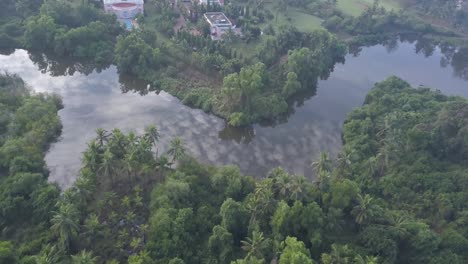 Clouds-Reflecting-On-The-Water---Tranquil-River-Near-Lalit-Resort-In-Canacona,-South-Goa,-India---aerial-drone-shot