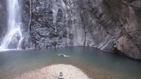 Tourist-Enjoying-Holiday-At-Mainapi-Waterfall-In-Netravali-Wildlife-Sanctuary,-South-Goa,-India