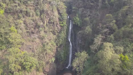 Agua-Cayendo-Desde-La-Altura-Y-Salpicando-Rocas-En-La-Cascada-Mainapi,-Santuario-De-Vida-Silvestre-Netravali,-Sur-De-Goa,-India