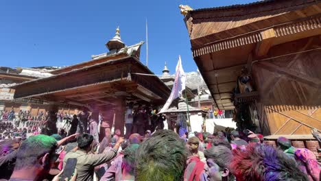 Indian-Crowd-Covered-With-Colorful-Gulal-Powders-Commemorating-The-Festival-of-Love-In-Sangla-Village,-Spiti-Valley,-Himachal,-India