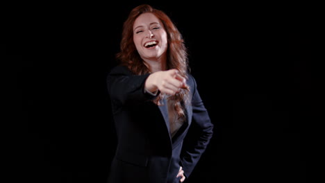 -A-caucasian-businesswoman-pointing-at-the-camera-and-laughing