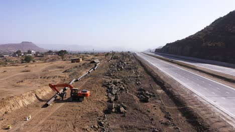 Forward-Aerial-Shot-Of-An-Ongoing-Pipeline-Construction-Beside-The-Road