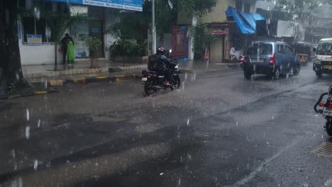 Monsoon-Season,-View-From-Dripping-Roof-Over-Street-With-Traffic,-India