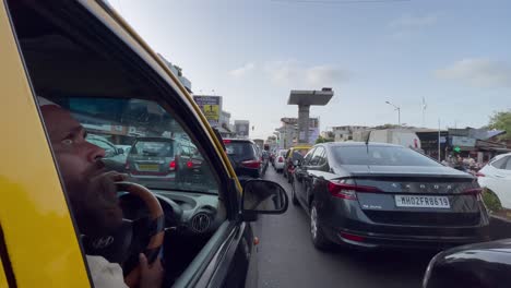 Car-Driver-Looking-Outside-Open-Window-In-The-Midst-Of-Traffic-Jam-And-Congestion-On-The-Road-During-Rush-Hour-In-Bandra,-Mumbai,-India