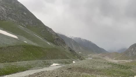 Point-Of-View-Of-Person-Driving-Near-Himalayan-Mountain-Ranges-With-People-Along-The-Road-During-Cloudy-Day