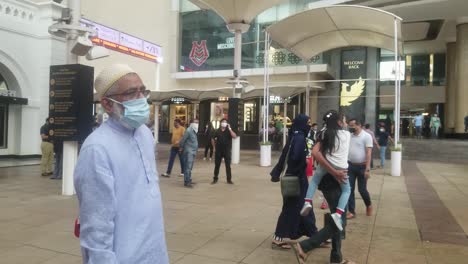 People-Walking-Outside-A-Luxurious-Shopping-Mall-In-Mumbai,-India---panning-shot,-slow-motion