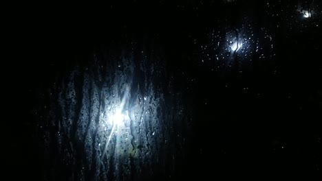 Water-dripping-from-rainfall-on-the-outside-of-a-car-window---Close-up