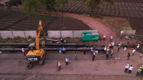 Aerial-View-Of-Engineers-And-Excavator-On-site-During-A-Pipeline-Construction-During-The-Day