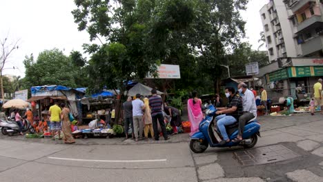 Vegetable-Vendors-On-The-Sidewalk-Along-The-Street-In-Mumbai,-India-Before-Sunset---fisheye-lens-view,-slow-motion