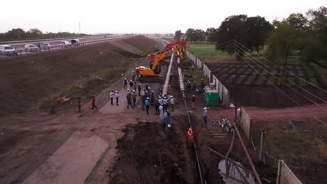 Aerial-Shot-Of-An-Occurring-Pipeline-Construction-With-Engineers-And-Excavators-On-site