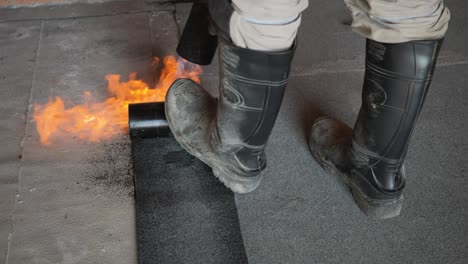 burning-bitumen-tar-floors,-waterproofing-the-floor-and-roof,-high-temperature-construction-work-by-contractor
