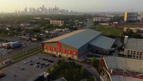 Vista-Aérea-Alrededor-De-Las-Instalaciones-De-Práctica-De-Fútbol-Bajo-Techo,-En-La-Universidad-De-Houston,-Hora-Dorada-En-Texas