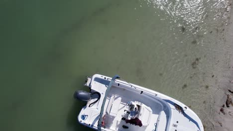 Dynamic-drone-flight-over-a-white-motorboat