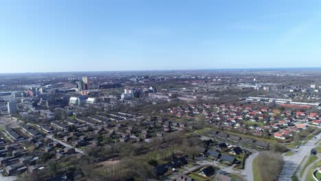 Swedish-city-of-Lund-on-blue-sky-day-with-suburban-homes-and-city-center,-aerial-wide