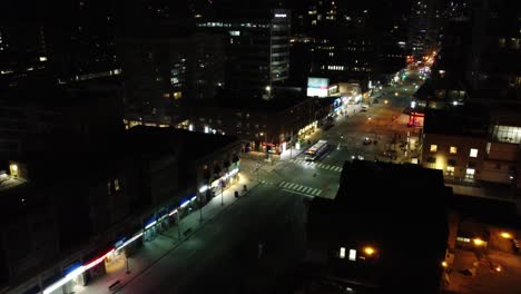 Night-aerial-in-Toronto-city-with-light-traffic,-illuminated-streets