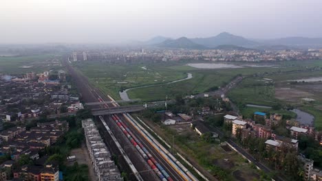 Aerial-of-Main-Railway-Station-in-Vasai,-Mumbai,-India-On-a-Misty-Day---drone-shot