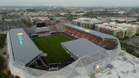 Aerial-view-flying-around-the-shell-energy-stadium,-sunrise-in-Houston,-Texas,-USA