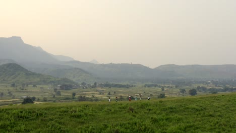 People-Carrying-And-Balancing-Bag-On-Their-Head-Walking-In-The-Green-Hills-At-Sunrise-In-Karjat-Near-Mumbai-City-In-India