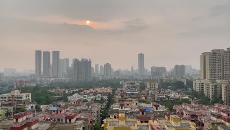 Aerial-slow-tilt-up-shot-of-Thane-city-during-sunset,-India