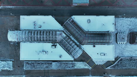 Top-Down-Aerial-View-of-Metro-Station-Building-in-Suburbs-of-Prague,-Czech-Republic-on-Cold-WInter-Day
