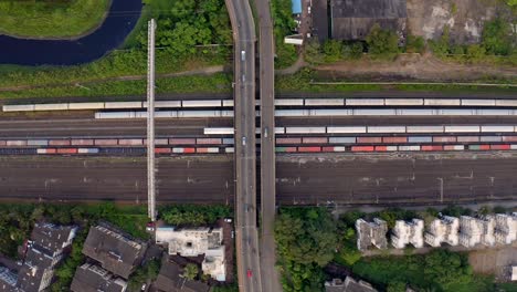 Bird's-eye-view-of-railroad-train-track-and-many-cargo-container-in-Vasai,-Mumbai,-India---drone-shot