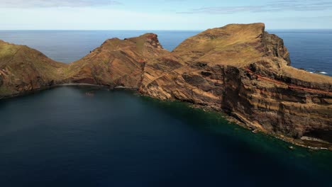 Ponta-de-Sao-Lourenco,-Madeira-aerial-view-towards-colourful-volcanic-hiking-mountain-coastline-and-turquoise-ocean-waves