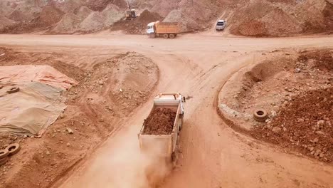 Drone-shot-of-truck-transporting-soil-for-mining-project-at-Hinatuan-Island,-Philippines