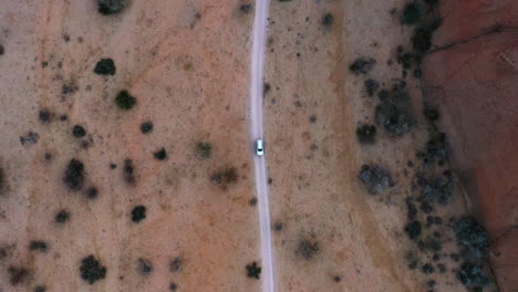Aerial-view-above-a-car-parked-on-a-distant-dirt-road,-in-Namibia---screwdriver,-drone-shot