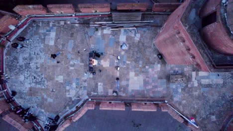 Aerial-top-down-view-of-a-DJ-mixing-at-the-top-of-Le-Castillet-in-France