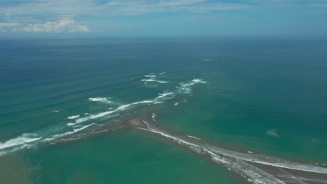 Beach-shaped-as-whale-tail-along-coast-of-Costa-Rica-with-blue-pacific-ocean