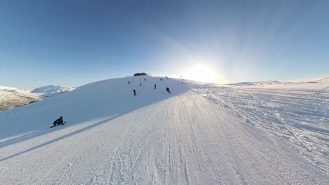Fast-reverse-dolly-past-skiers-skiing-towards-camera,-Myrkdalen-Ski-Resort,-Norway
