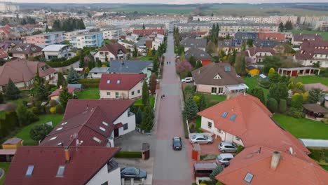 Black-car-driving-through-a-quiet-neighborhood-of-family-houses-on-the-outskirts-of-the-city-of-Svitavy