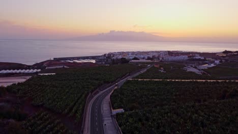 Coastal-town-of-San-Juan-and-banana-plantations-in-foreground-after-sunset