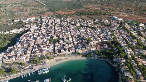 Panoramic-Aerial-View-Of-Porto-Cristo-Coastal-Town-Near-Sa-Coma,-Eastern-Coast-Of-Mallorca,-Spain