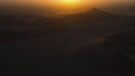 Warm-hazy-evening-at-the-dunes-of-the-Namib-desert,-Namibia,-Africa---aerial-view
