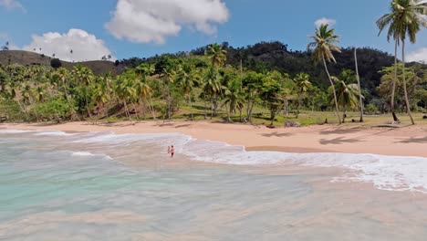 Couple-in-sea-waters-of-Playa-Colorada-beach,-Las-Galeras-in-Dominican-Republic