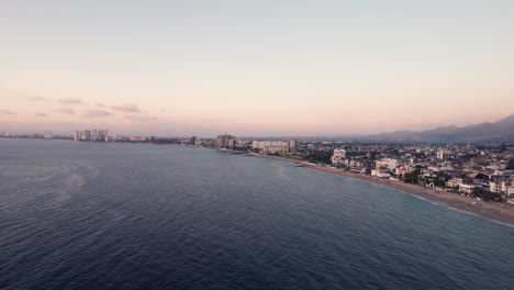 Drone-video-showcasing-the-vast-Banderas-Bay-and-Puerto-Vallarta,-featuring-the-hotel-zone-and-the-sea-along-the-coast